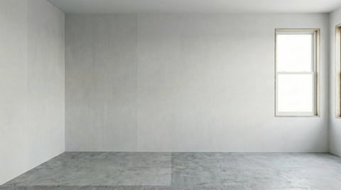 Empty room with white walls, concrete floor, and a window on the right side